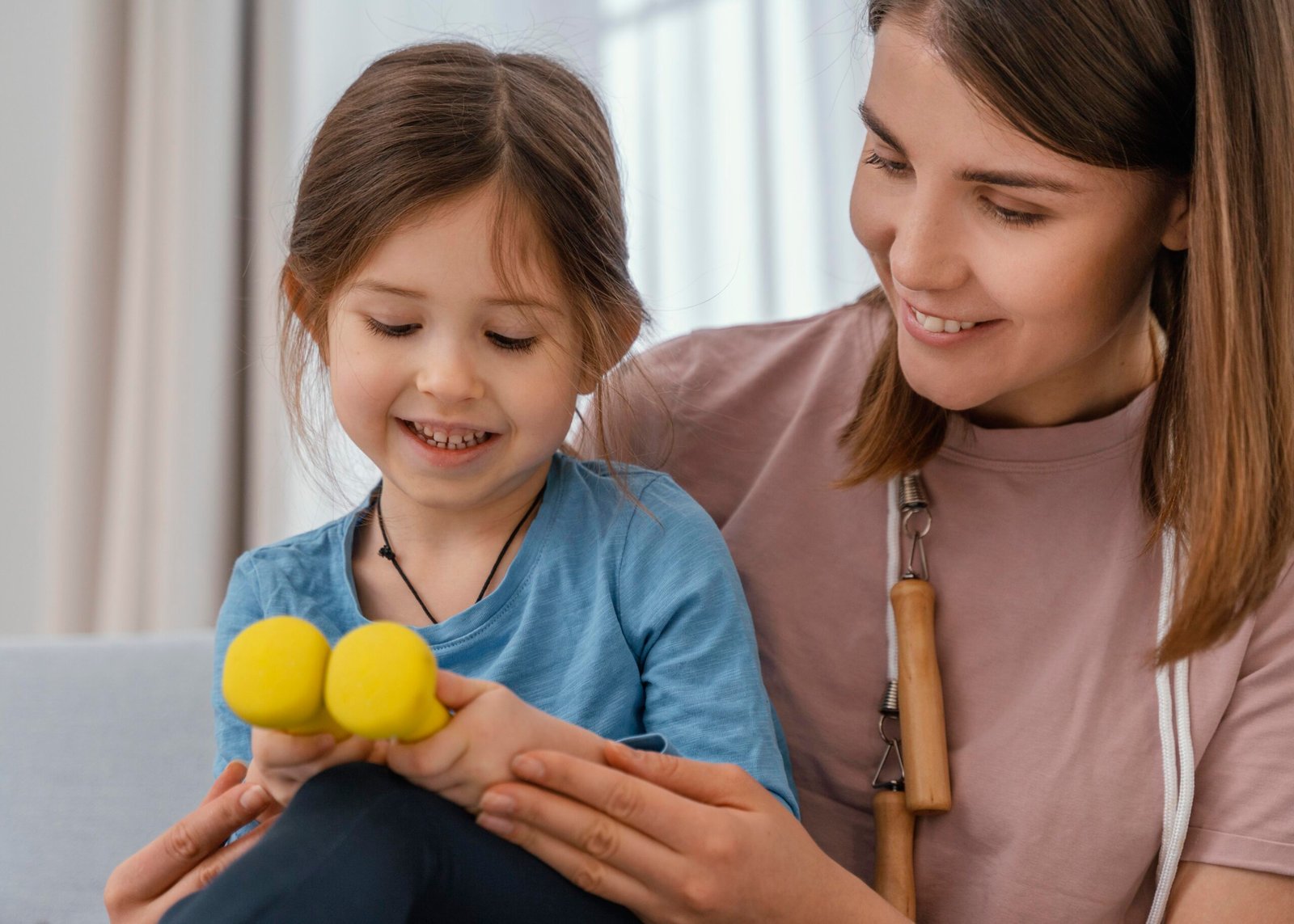 close-up-girl-holding-dumbbells